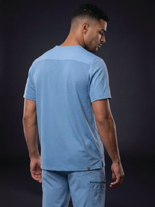 Kyür Canton V-Neck men's medical scrub top in light blue - side view showing chest pocket and matching pants