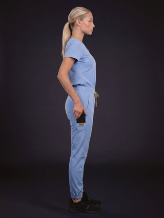 Kyur women's light blue jogger-style scrub set, side profile view