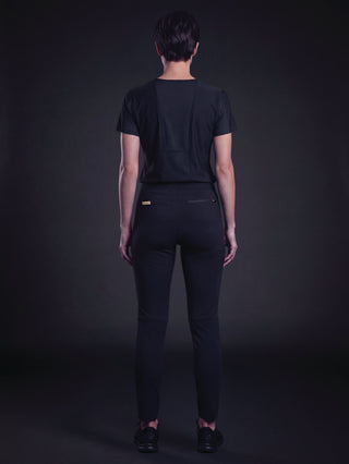 Kyur women's dark purple scrub top and slim-fit pants, full back view