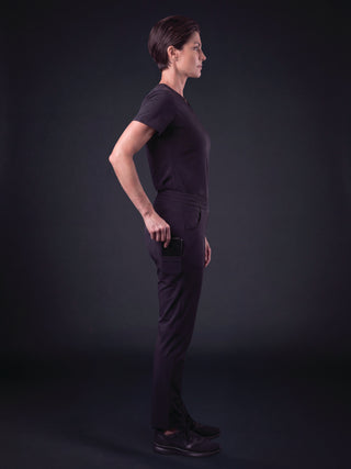 Kyur women's dark purple scrub top and pants, side profile view
