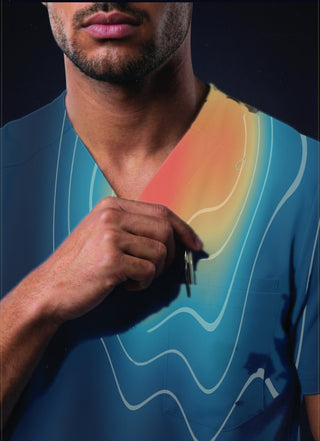 Kyur DELTA thermoregulation map on a men's blue V-neck scrub top, illustrating heat zones across the chest