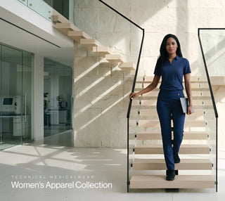 A woman in a matching royal blue technical medical uniform walks down a modern staircase in a bright, contemporary building lobby. The image is labeled 'TECHNICAL MEDICALWEAR Women's Apparel Collection' in the bottom left corner.